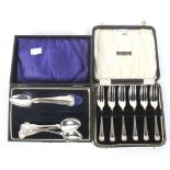 Two sets of silver flatware.