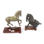 Two cast metal models of horses.