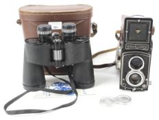 A cased Rolliecord (German) camera and cased pair of Swift binoculars.