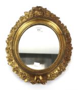 An early 20th century giltwood oval mirror.