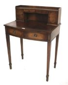 An early 20th century mahogany and rosewood veneered desk.