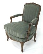 A French Chateau style open green upholstered elbow chair.