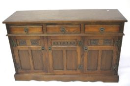 A stained oak Old Charm Wood Brothers sideboard in the Arts and Crafts style.
