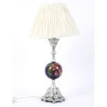 A Moorcroft Pottery Hibiscus pattern and silvered resin mounted table lamp.