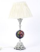 A Moorcroft Pottery Hibiscus pattern and silvered resin mounted table lamp.
