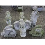 Six composite stone garden statues.