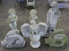 Six composite stone garden statues.
