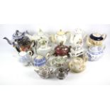 A collection of English pottery and porcelain tea and coffee pots,