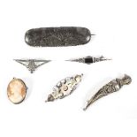 A collection of six vintage silver brooches.