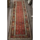 A 20th century red ground Kazak style runner.