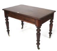 A 19th century mahogany table. On turned baluster supports and casters, 106cm x 68cm x H73.