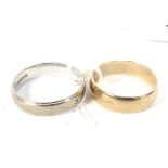 A 9ct yellow gold and a white metal 9ct gold wedding ring band. Sizes R & T, weight 7.