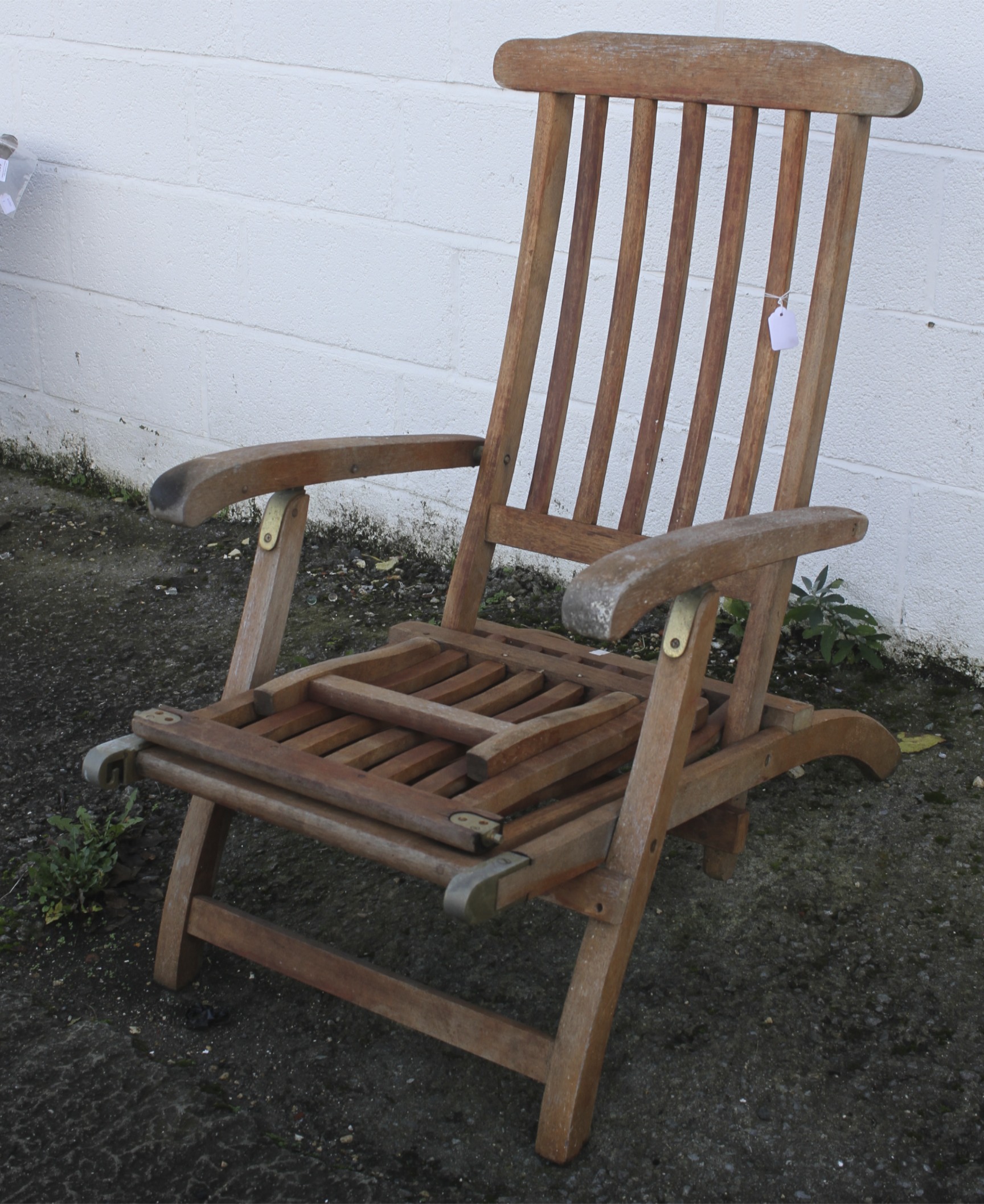 A contemporary wooden slatted garden sun chair.