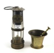 A brass miner's lamp by Thomas & Williams of Aberdare and a brass mortar and pestle.