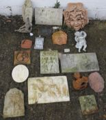 A collection of garden wall plaques.