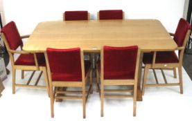 A 20th century hand crafted oak dining table and six chairs.