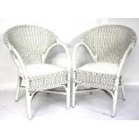 A pair of bamboo and wicker chairs.