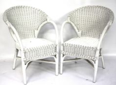 A pair of bamboo and wicker chairs.