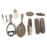 An assortment of silver backed ladies dressing table accessories.