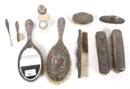 An assortment of silver backed ladies dressing table accessories.