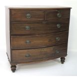 A 19th century bow fronted chest of drawers.