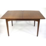 A mid-century teak extendable dining table.