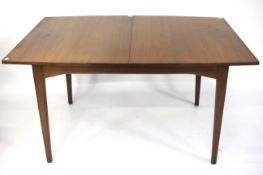 A mid-century teak extendable dining table.