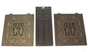 Three carved wooden wall hangings.