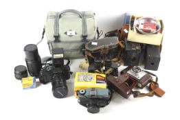 Assorted vintage binoculars and cameras.