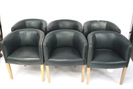 A set of six tub shaped chairs on tapering beech legs.