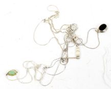 A selection of six silver and white metal necklaces and pendants.
