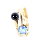 Two yellow metal rings. One set with a blue stone, size Q, the other a black stone, size O, 2.