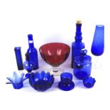 An assortment of blue and cranberry glassware.
