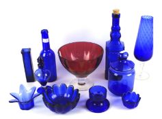 An assortment of blue and cranberry glassware.