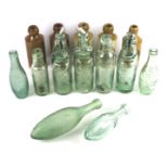 An early 20th century codd neck glass bottle and stoneware ginger beer bottles.