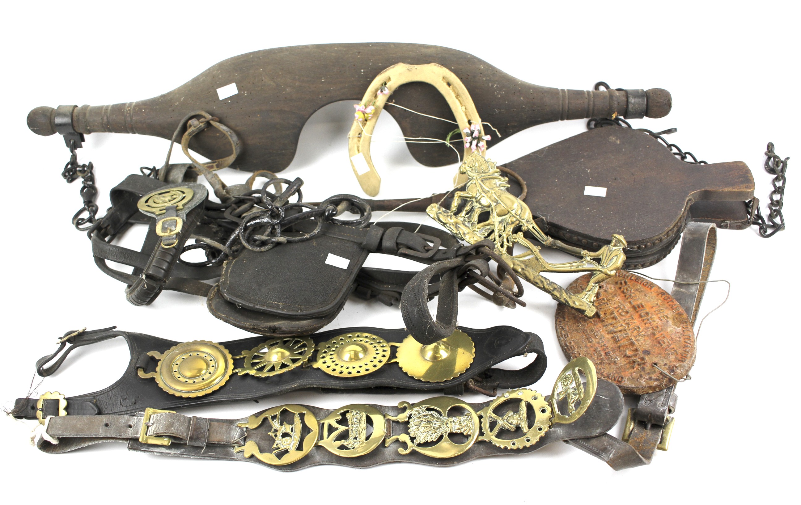 An assortment of horse brasses and other items.
