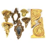 An assortment of carved and gilded wall brackets and a pair of wall mounting mirrors.