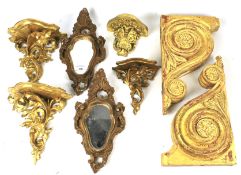 An assortment of carved and gilded wall brackets and a pair of wall mounting mirrors.