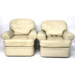 Two contemporary cream upholstered armchairs.
