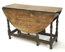 A 19th century oak drop leaf table.