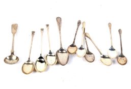 An assortment of silver teaspoons.