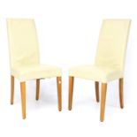 A pair of contemporary high back dining chairs.