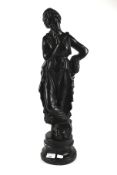 A large black painted plaster figure of a lady in neo-classical dress.