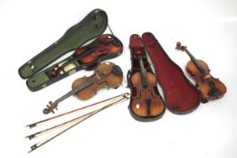 Four 20th century violins and three bows.