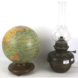 A paper covered globe adapted into a table light and a brass oil lamp.