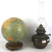 A paper covered globe adapted into a table light and a brass oil lamp.