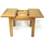 A modern oak extending dining table.