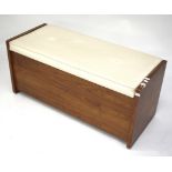 A mid-century teak storage bench. The hinged top with padded seat, all raised on casters.