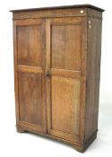 A mid-century oak wardrobe.