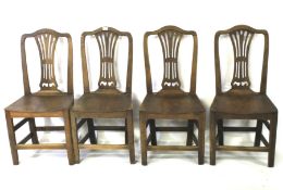 A set of four Georgian oak dining chairs.